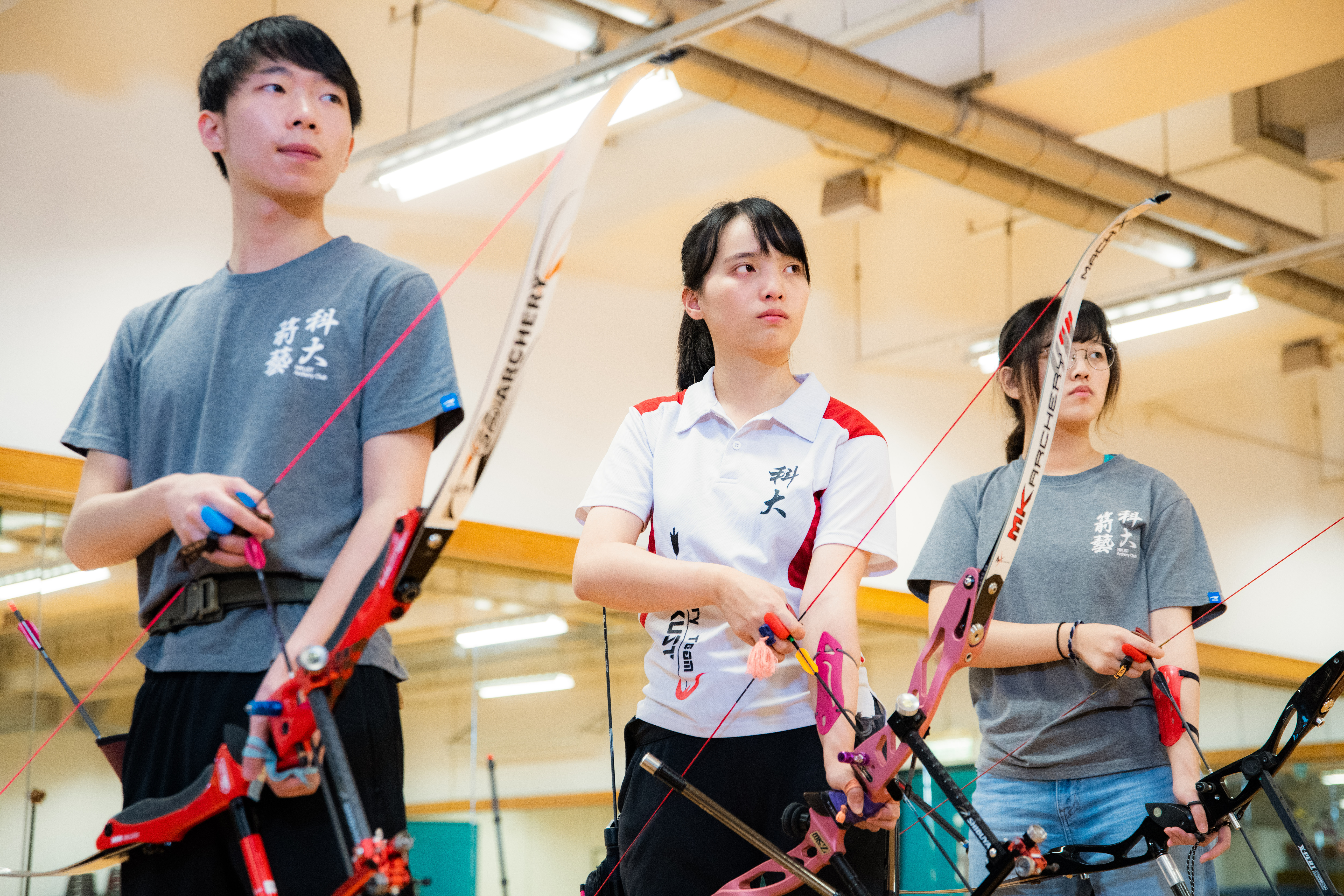 Edith practices archery with teammates regularly.