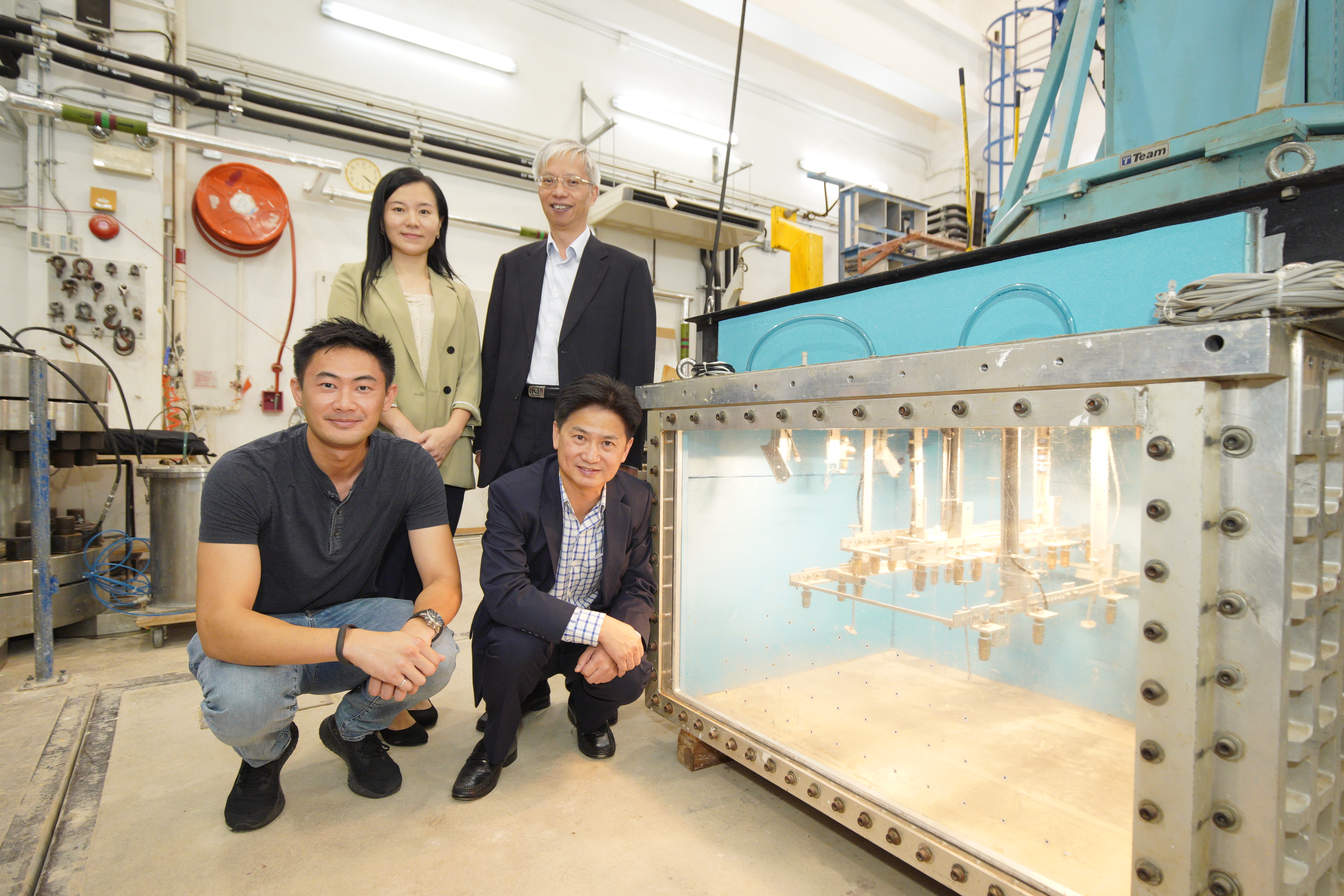 Prof. Charles NG, Associate Vice-President (Research and Development) of HKUST (front right) and the Project Coordinator; Mr. PUN Wai-Keung, Head of Geotechnical Engineering Office of the HKSAR Government (back right); Ms. Eva LAM, Director of Hong Kong Jockey Club Disaster Preparedness and Response Institute (back left); and Dr. Clarence CHOI, Research Assistant Professor, Civil and Environmental Engineering of HKUST with the centrifuge environmental chamber developed by HKUST.