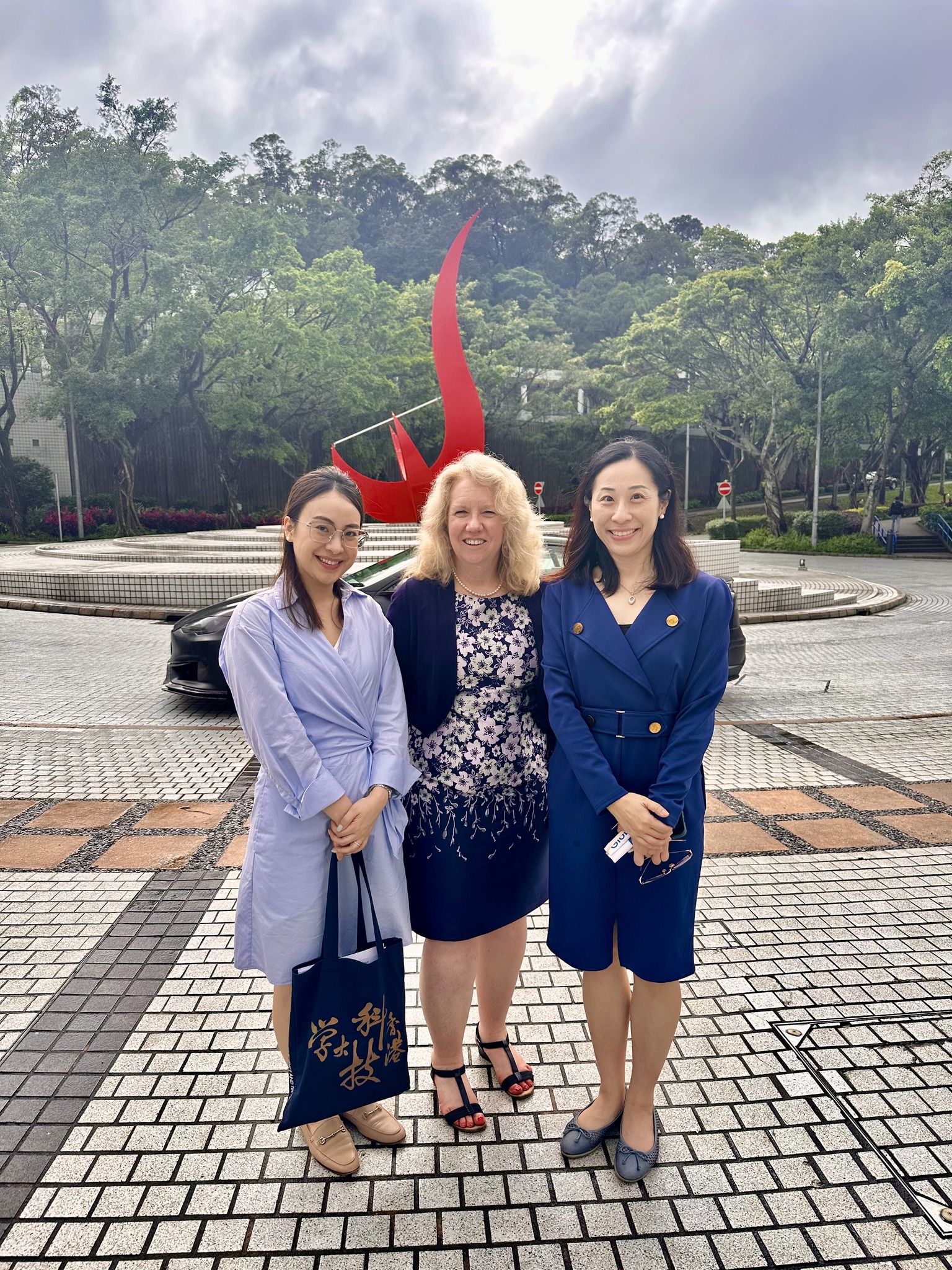 Dr. CROUGHAN takes a photo in front of the iconic “Red Bird” sculpture at the Piazza.
