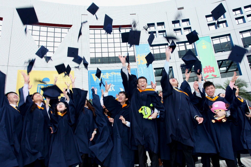  Graduates throwing their caps high in the air in celebration.