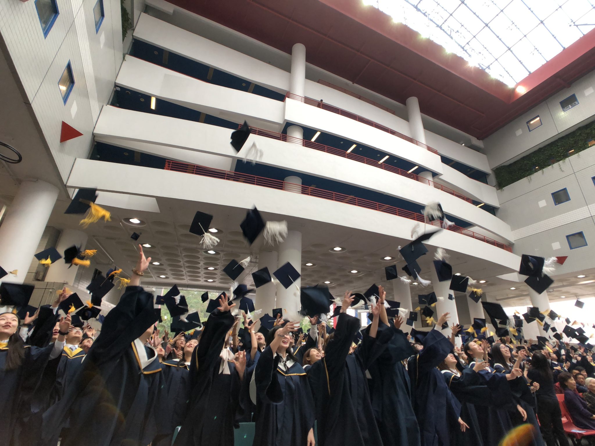  Graduates toss their hats in jubilation as the Congregation concludes.