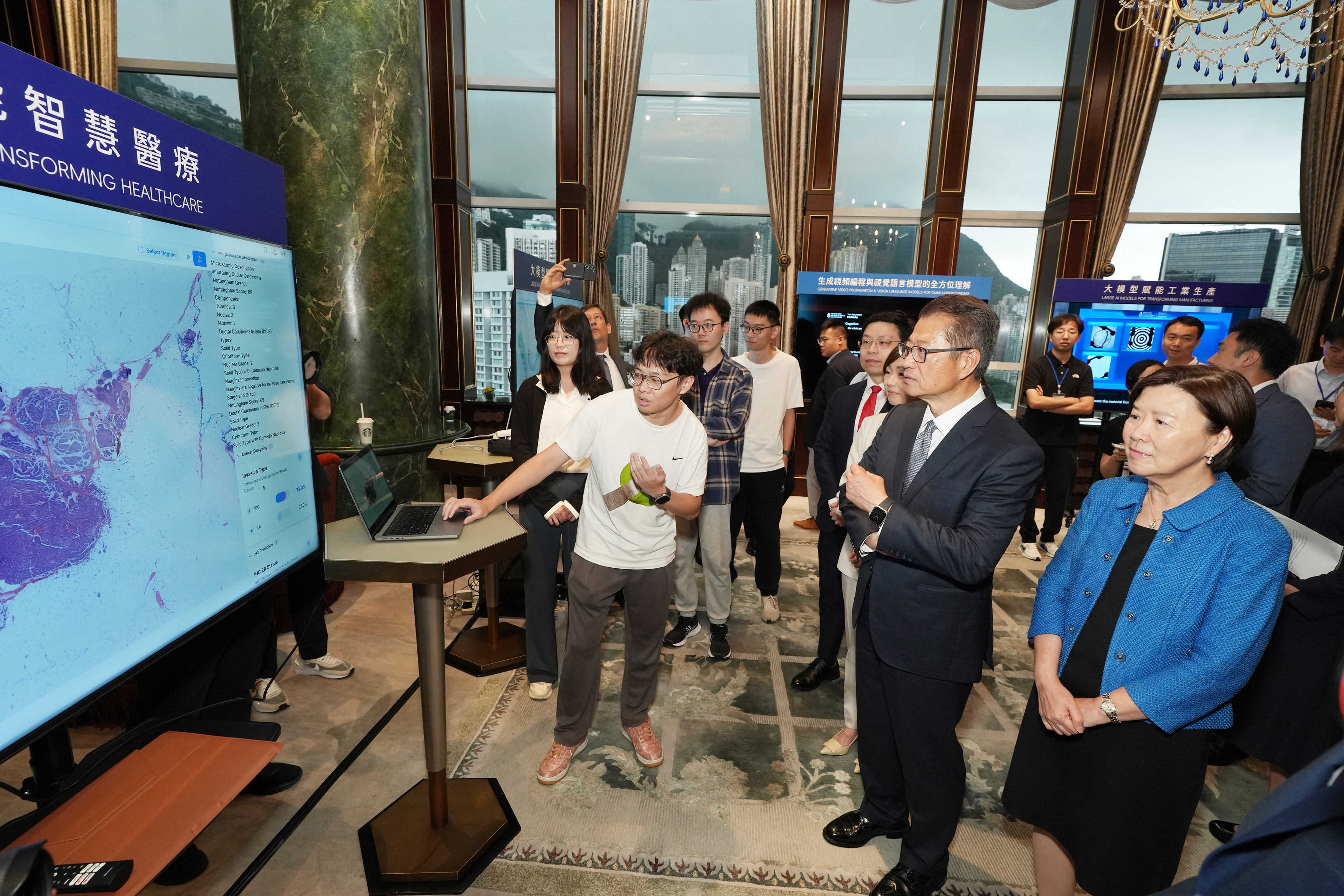 A research team from HKUST showcases a series of AI medical models to the guests. 