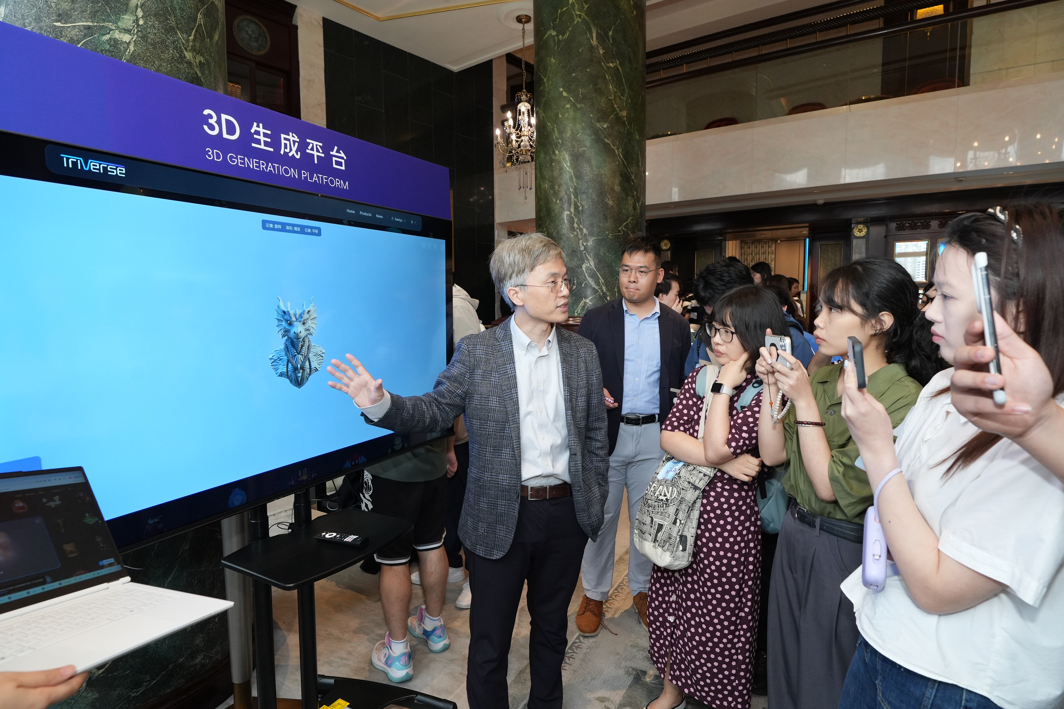 Prof. Tan Ping (first left) introduces his 3D Generation Platform. The platform is currently available for public trial on the website triverse.ai.