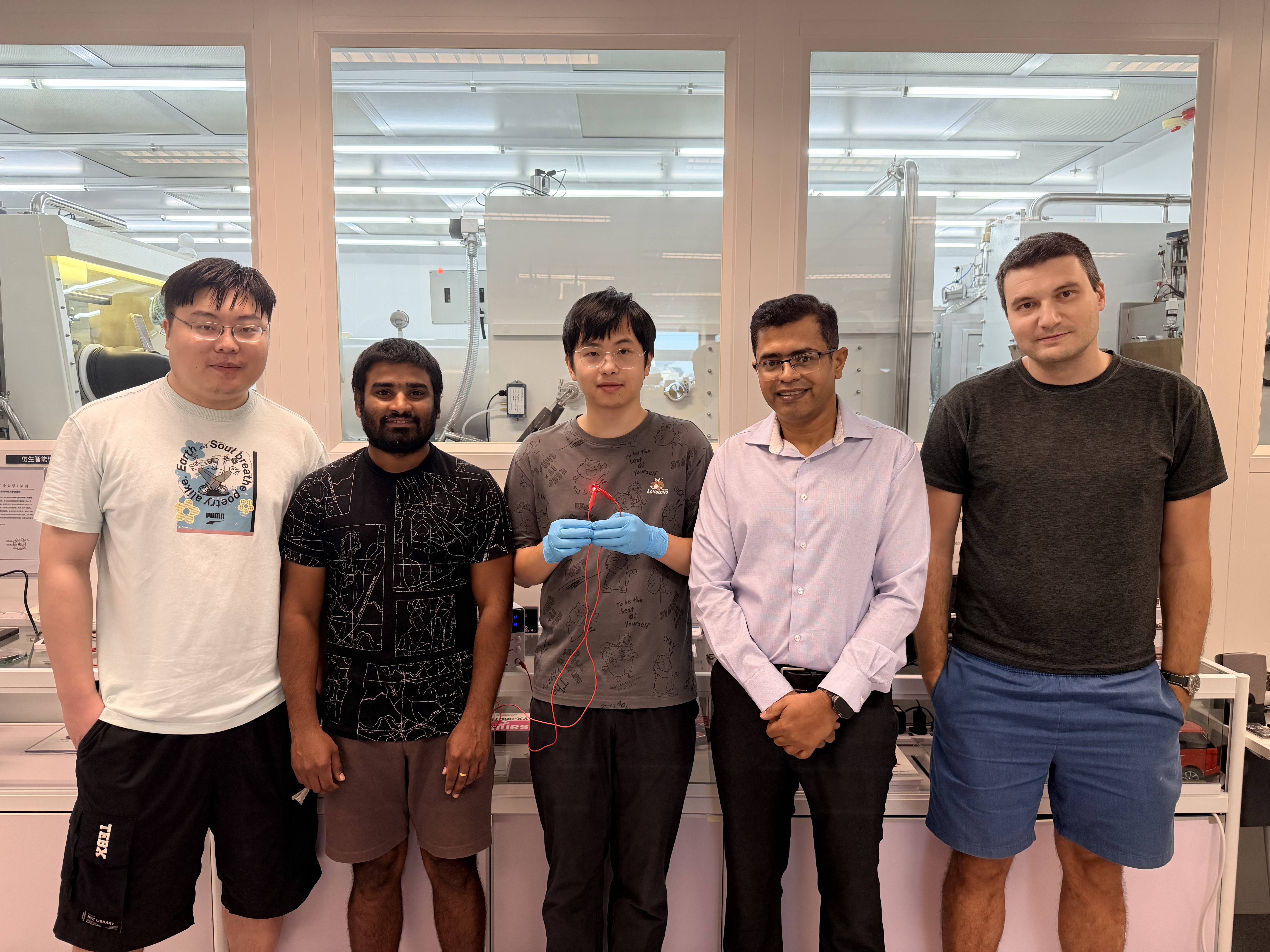 Group photo of the research team: Prof. Abhishek K. Srivastava (second right), corresponding author of the study; Liao Zebing (center), PhD student and first author of the study; as well as co-authors including postdoctoral fellow Dr. Maksym Prodanov (first right), PhD students Mallem Kumar (second left) and Song Jianxin (first left). Mr Liao holds a red emitting QR-LED sample.