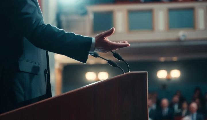 A man delivering a speech on stage