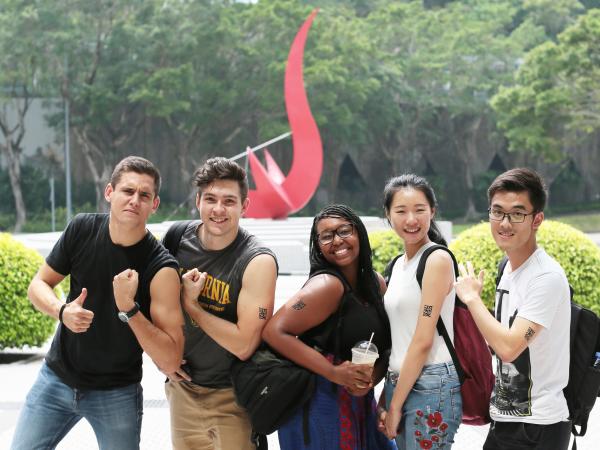 students posing in front of the HKUST red bird sundial