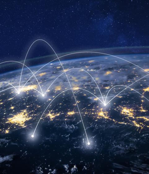 Overhead photo of Earth with digital lines connecting various places